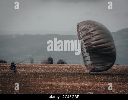 Amazing shot of an airborne forces soldier landing in a mission zone Stock Photo