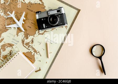Planning vacation, travel plan, trip vacation using world map along with other travel accessories. Top view, flat lay.  Stock Photo