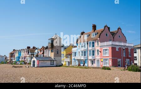 Colourful buildings facing the beach on a sunny day with blue sky. Aldeburgh, Suffolk. UK Stock Photo