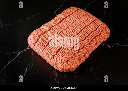 Raw ground beef with texture on black background. Top view. Stock Photo
