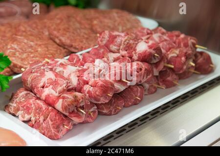 Raw meat in butcher's shop Stock Photo