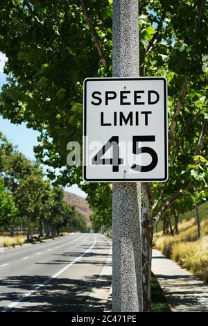 45 miles per hour speed limit sign on road side. Stock Photo