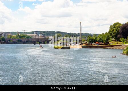 The Moselle River in the city center in West Germany, visible old concrete bridge and port for launching water units. Stock Photo