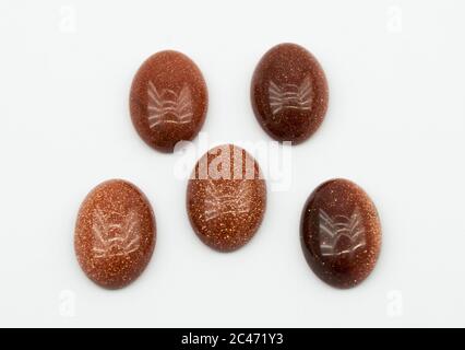 Natural oval cabochon brown aventurine gold on the white background Stock Photo