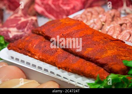 Raw meat in butcher's shop Stock Photo