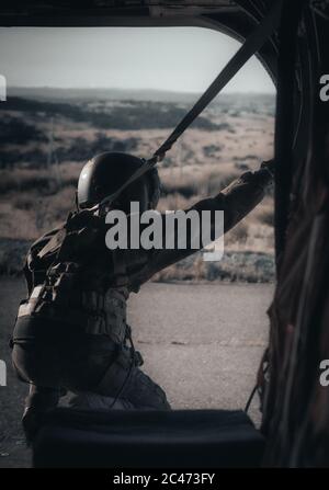 Amazing shot of an airborne forces soldier going to jump from a helicopter Stock Photo