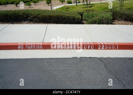 Close-up of red painted curb with Fire Lane text. Stock Photo