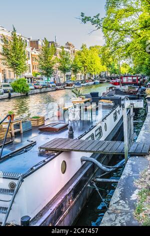 Amsterdam, Netherlands - July 19, 2018: Typical boathouses, on the Amsterdam canals Stock Photo