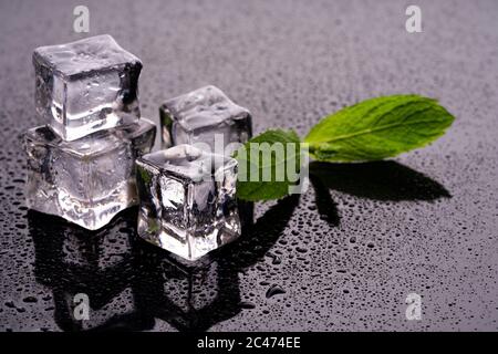 Ice cubes and mint on wet background Stock Photo