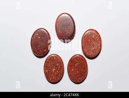 Natural oval cabochon brown aventurine gold on the white background Stock Photo