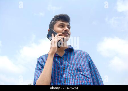 Teen man busy in phone. handsome young man Stock Photo