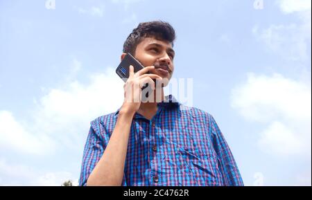 Teen man busy in phone. handsome young man Stock Photo