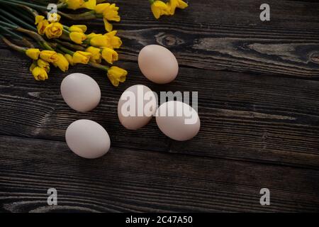 Chicken eggs white and brown. eggs in straw, on a wooden background Stock Photo