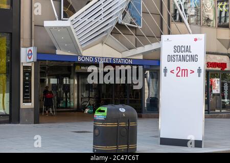 London Bond Street Underground station with a social distancing notice in  front on the street. Stock Photo