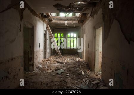 Dark shadow in the end of the hallway of abandoned hospital Stock Photo