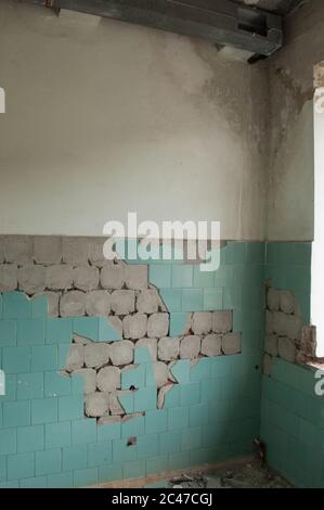Ruined room with fallen blue tile Stock Photo