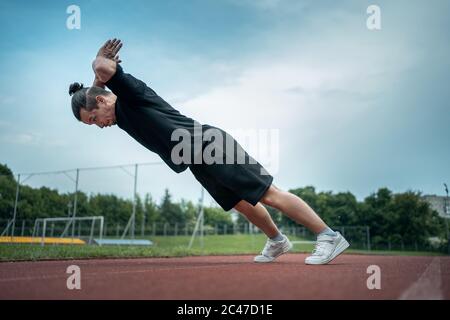 young athlete push up and jump at stadium outdoor Stock Photo