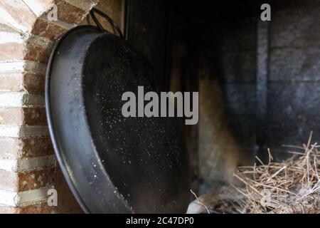 Black metal tray next to the brick wall Stock Photo