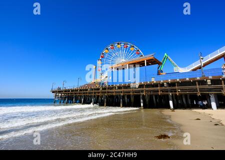 Ocean Park amusements roller coaster and ferris wheel on the pier. “Santa Monica” California United States of America
