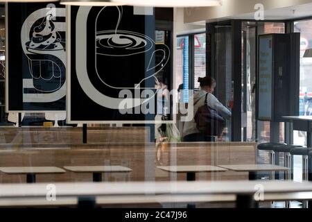 Eastleigh Hampshire, UK. June 24th 2020, Female customer exiting McDonald's fast food restaurant by folowing social distancing one way system Eastleigh, Hampshire, UK Credit: Dawn Fletcher-Park/Alamy Live News Stock Photo