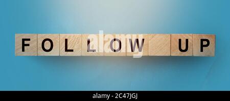 FOLLOW UP words written on wooden building blocks. Social media promotion business concept Stock Photo
