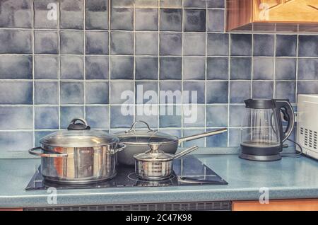 empty pan on stove with stands on table closeup modern kitchenware Stock Photo