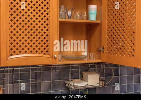 plates are dried on a shelf for dishes in the kitchen cabinet Stock Photo