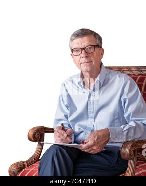 Senior caucasian adult checking a document in hand while seated. He is wearing a pair of glasses and cutout against white Stock Photo
