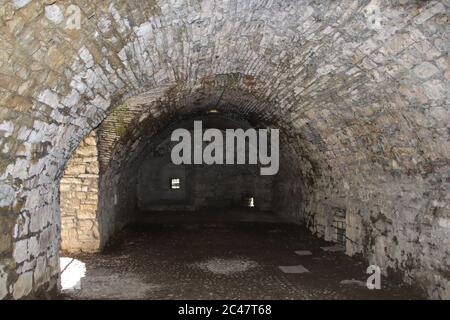 Dungeons of a medieval castle. Passage in the fortress wall. Black and ...