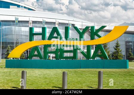 Almaty, Kazakhstan - June 13, 2020: ice sport arena Almaty city - Halyk Arena. Close-up logo on green grass Stock Photo