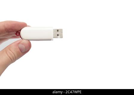 USB flash drive close up shot held between fingers by Caucasian male hand isolated against white background 2020 Stock Photo
