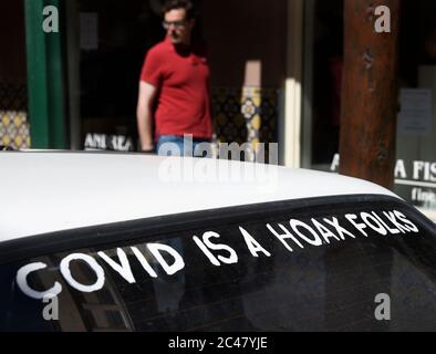 A car with 'Covid is a hoax folks' painted on the rear window in Santa Fe, New Mexico. Stock Photo