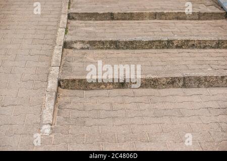 View of stairs and a wheelchair ramp on the street during daytime Stock Photo
