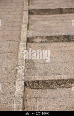 Vertical shot of stairs and a wheelchair ramp on the street during daytime Stock Photo