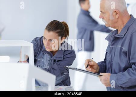 portrait of supervisor assessing female apprentice Stock Photo