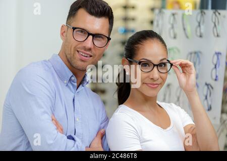 portrait of male and female workers in opticians Stock Photo