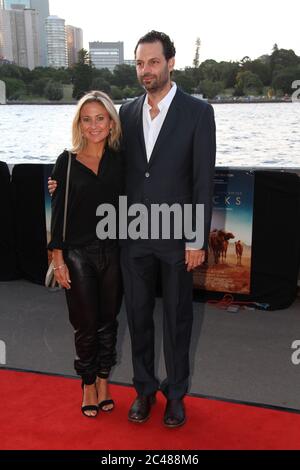 Tracks Producer Emile Sherman and wife Caroline Sherman arrive on the red carpet for the St George Openair Cinema’s opening night Sydney premiere of ‘ Stock Photo