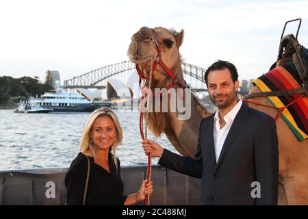 Tracks Producer Emile Sherman and wife Caroline Sherman pictured with the male camel ‘Syd’ as they arrive on the red carpet for the St George Openair Stock Photo