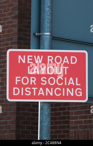 Eastleigh, UK. 24th June, 2020. Temporary new road layout sign enforcing social distancing as restrictions are lifted for the first time since the government mandated non-essential businesses to close due to the coronavirus pandemic. Credit: SOPA Images Limited/Alamy Live News Stock Photo