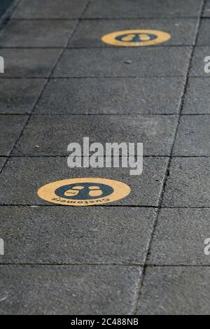 Eastleigh, UK. 24th June, 2020. Pavement outside McDonald's fast food restaurant with social distancing signs as restrictions are lifted for the first time since the government mandated non-essential businesses to close due to the coronavirus pandemic. Credit: SOPA Images Limited/Alamy Live News Stock Photo