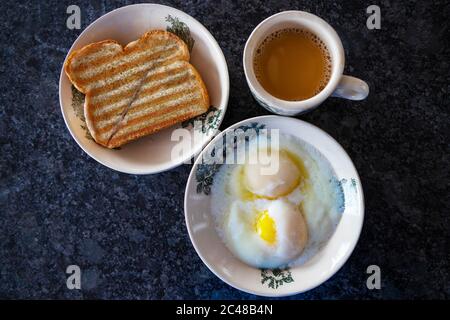 Traditional breakfast popular in Singapore and Malaysia consisting of half boiled eggs, kaya butter toast and cup of milk coffee. Kaya is a special sp Stock Photo