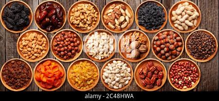 Various dried fruits and nuts on a wooden table. Top view flat lay Stock Photo