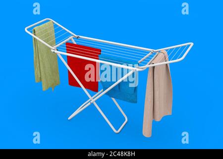 Clothes over White Folding Metal Clothes Drying Rack on a blue background. 3d Rendering Stock Photo