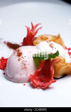 Strawberry ice cream with whipped cream and caramelized flower. Stock Photo