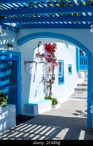 Traditional Greek architecture with whitewashed walls and blue accents, taken in a village on the island of Santorini. Stock Photo