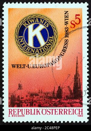 AUSTRIA - CIRCA 1983: A stamp printed in Austria shows Kiwanis Emblem and View of Vienna, circa 1983. Stock Photo