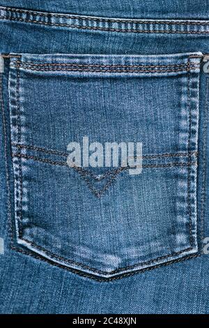 close view of  blue denim stone washed rear jean pocket Stock Photo