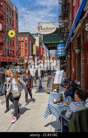 People walking on Mulberry street in the Little Italy district. Lower Manhattan, New York City, USA. Stock Photo