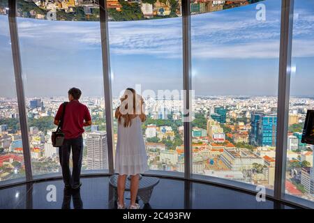 Tourists enjoy the view of the Ho Chi Minh City from the Bitexco Financial Tower observation deck. Ho Chi Minh City, Vietnam. Stock Photo