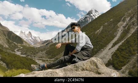 Young man posing with the mountains in the background Stock Photo
